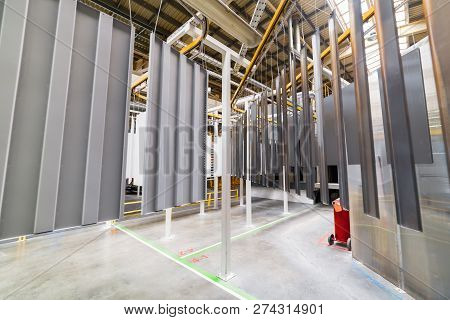 Powder Coating Line. Metal Panels Are Suspended On An Overhead Conveyor Line. Painting Products In A