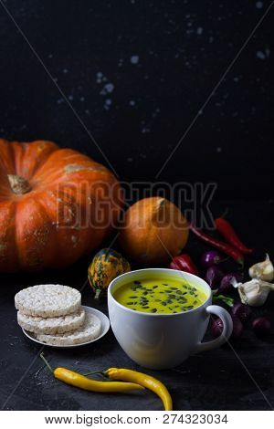 Pumpkin Asian Coconat Cream Soup. Autumn Hot Food. Chili Pepper, Garlic, Red Onion, Big Pumpkin. Dar