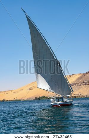 Felucca With White Sails, Sailing Along The Nile River At Aswan - Egypt