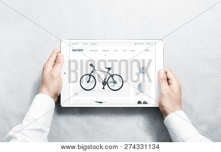 Hands Holding Tablet With Sport Webstore Mock Up On Screen