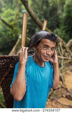 Meghalaya, India - May 15, 2017: Khasi man carrying traditional bamboo basket in Meghalaya state, India