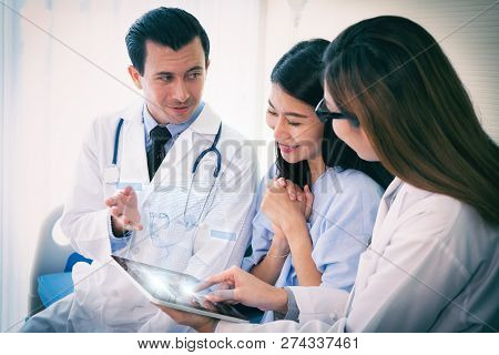 Teams Of Doctors Examining With 3d Vistual Face About Facial Lift Surgery Program To The Patient  At