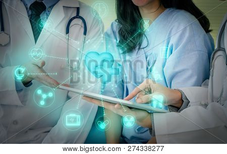 Team Of Doctor Examining A Female Patient On Bed In Hospital With Madical Icon On Digital Screen