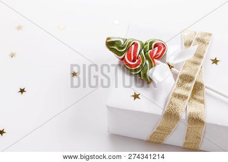 Christmas Composition. Xmas Pink Decor, Christmas Candy Cane With Ribbon On White Background.