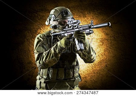 Fighter Of A Special Unit Is Aiming At The Sight Of The Machine Gun. Mixed Media