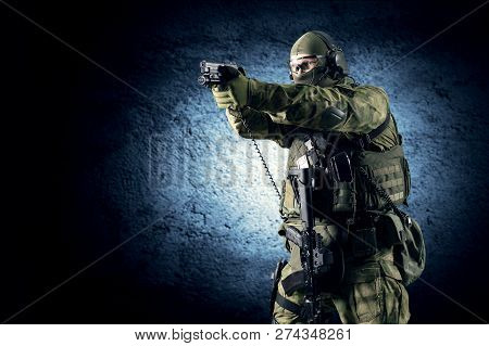 Fighter Of A Special Unit Is Aiming At The Sight Of The Machine Gun. Mixed Media