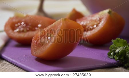 Sliced Tomato Falling On Chopping Board, Super Slow Motion. Falling Parts Of Sliced Tomatoes On A Wo