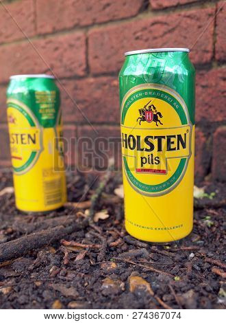 Bracknell, England - December 16, 2018: Two Discarded Empty Holsten Pils Beer Cans Left On A Path Be