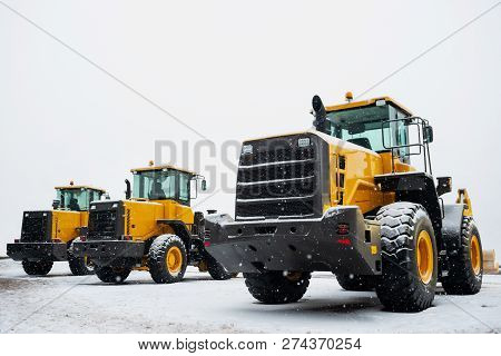 Yellow Wheel Front Loaders. Construction And Handling Equipment. Heavy Diesel Tractor, Construction 