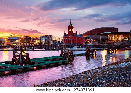 Waterfront At Night In Cardiff, Uk. Sunset Colorful Sky With Wales Millennium Center