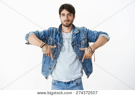 Studio Shot Of Stylish Handsome Hispanic Male With Beard And Blue Eyes In Trendy Denim Jacket Over S