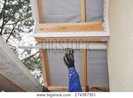 Contractor Installing Soffit Board. Roofing Construction. Soffit And Fascia Is  Constructed Of Vinyl