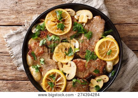 Italian Main Course Veal Scaloppini Cooked With Mushrooms And Lemons In A Spicy Sauce, Close-up. Hor
