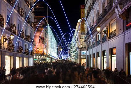 Madrid, Spain, December 2018. People Walking And Shopping On Preciados Street At Nightfall, Illumina