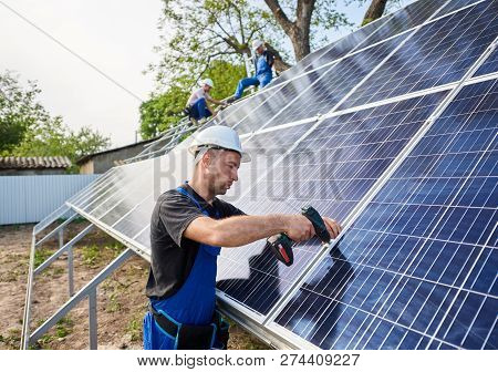 Professional Engineer Technicians Connecting Exterior Solar Photo Voltaic Panel To Metal Platform On