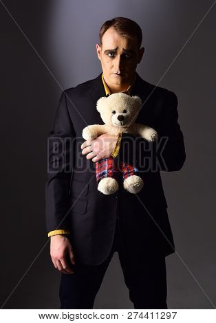 Depressed And Lonely. Mime Man Hold Teddy Bear Toy. Stage Actor With Mime Makeup In Toy Shop. Theatr