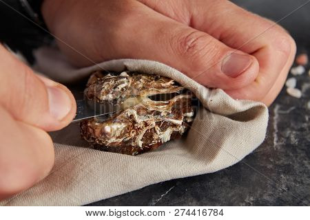 View Of Male Hands Shucking Fresh Oyster, Close Up View
