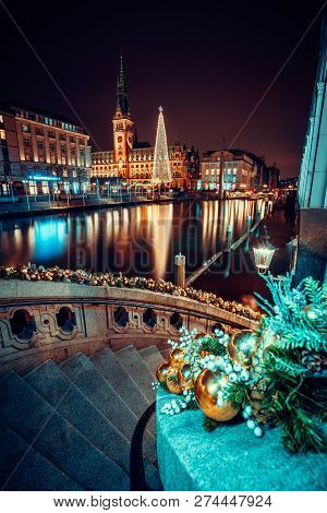 Christmas Time At Alsterfleet And The City Hall In Hamburg At Night. Beautiful Illuminated Downtown,