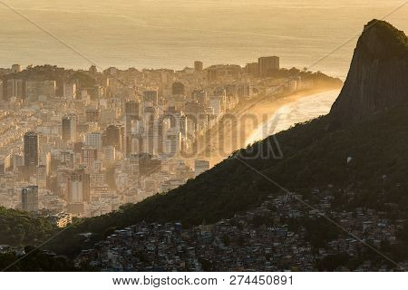 View Of Favela Rocinha At Sunrise With Ipanema District Behind, In Rio De Janeiro, Brazil