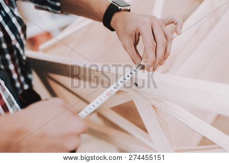 Young Man Assembling Wooden Bookshelf At Home. Wooden Bookcase. Selfmade Furniture. Man And Hobby. W