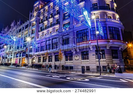 Madrid, Spain - December 15, 2018: Gran Via Avenue Illuminated At Christmas With Neon Lights And Tra