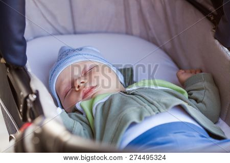 Baby Sleeps In Pram While Family Walk