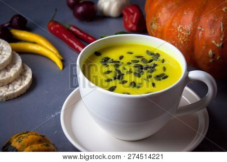 Pumpkin Asian Coconat Cream Soup. Autumn Hot Food. Chili Pepper, Garlic, Red Onion, Big Pumpkin. Dar
