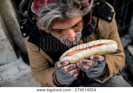 A Top View Of Homeless Beggar Man Outdoors In City, Holding Hot-dog.