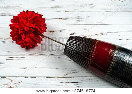 Lying Vase With Artificial Red Flower On Wooden Rustic Background