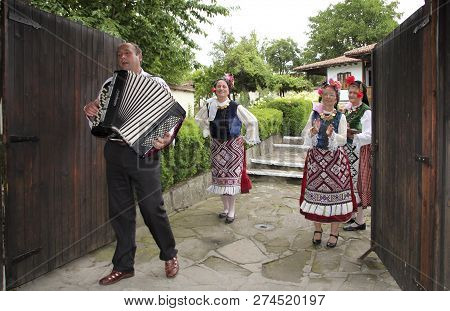 Alfatar, Bulgaria - August 09 2018: A Folk Song Group In The Yard Of A Traditional Bulgarian Village