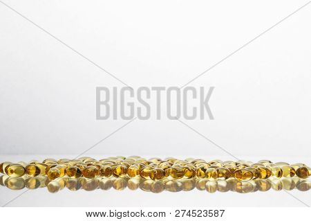 Fish Oil Supplement Capsules Isolated On White Background