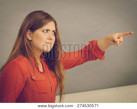 Angry, Pissed Off Young Woman. Attractive Female With Long Brown Hair Sitting On Sofa Being Mad And 