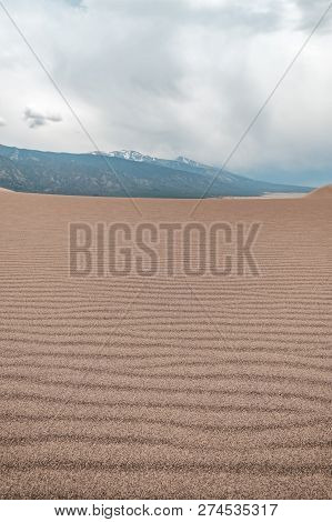 Layers Of Sand, Sand Texture, With Stormy Skies In Great Sand Dunes National Park In Colorado, Usa