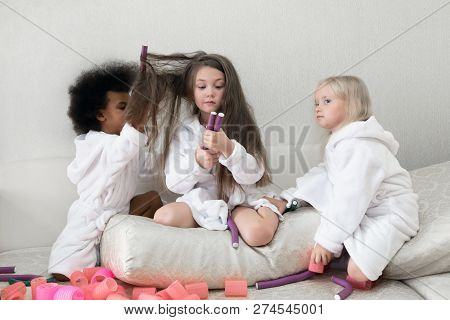 Little Girls Play With Hair Curlers And Hairpins.