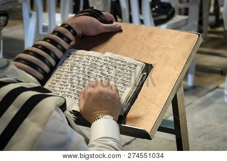 Jerusalem, Israel. 24 October 2018: Religion Jew Reading Prayer Book. Torah On The Table In Front Of