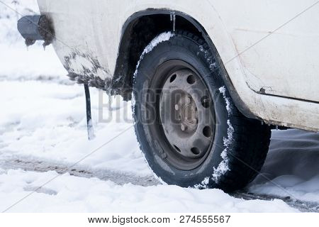 The Road Is Covered With White Snow. Slippy Road. Close Up Of A Cars Tires On A Snowy Road