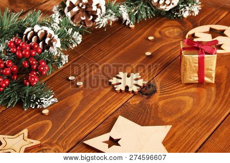 Spruce Branches, Cones And Red Berries On A White Wooden Background. Background For Christmas And Ne