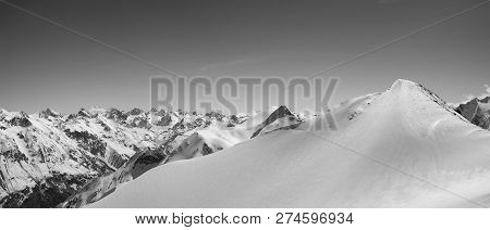 Black And White Panorama Of Snowy Mountains And Ski Slope For Freeriding At Sunny Winter Day. Caucas