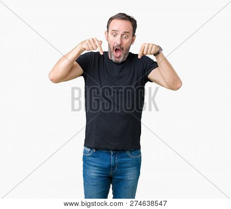 Handsome middle age hoary senior man over isolated background Pointing down with fingers showing advertisement, surprised face and open mouth
