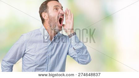 Handsome middle age elegant senior man over isolated background shouting and screaming loud to side with hand on mouth. Communication concept.