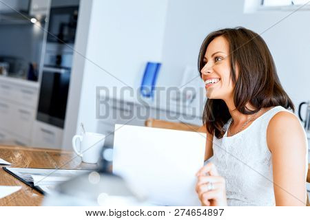 Woman with papers in their living room