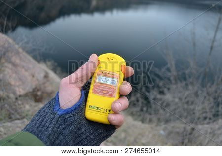 Modern Ukrainian radiometer near Radon Lake, located in Migeia (former granite quarry,filled with water).The radiometer gives readings in micro-Sieverts. December 15,2018. Migeia, Ukraine