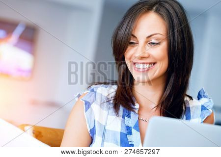 Woman with papers in their living room