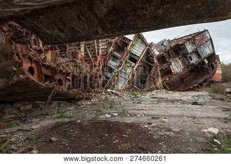 Huge Rusty Pieces Of Decommissioned Marine Ship That Was Cut And Left On The Shore.