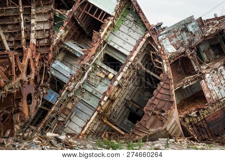 Huge Rusty Pieces Of Decommissioned Marine Ship That Was Cut And Left On The Shore.