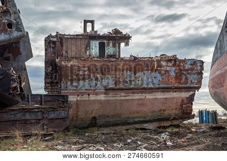 Huge Rusty Pieces Of Decommissioned Marine Ship That Was Cut And Left On The Shore.