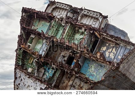 Huge Rusty Pieces Of Decommissioned Marine Ship That Was Cut And Left On The Shore.