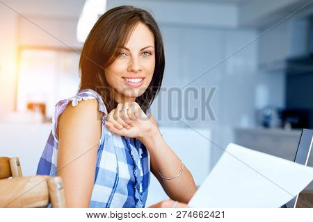 Woman with papers in their living room