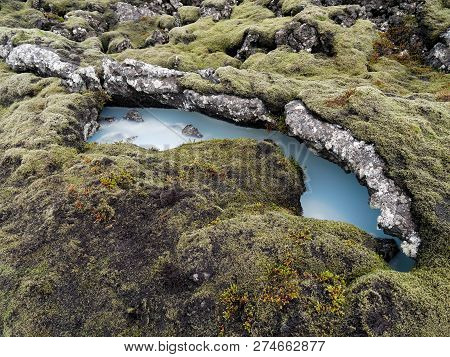 Silica Mud Rich Water Surrounded By Moss Covered Rock, Reykjanes Peninsula, Iceland