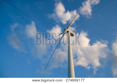 View Up, Bottom View Of Wind Turbine, Windmill Isolated On Blue Sky Background. Royalty High-quality